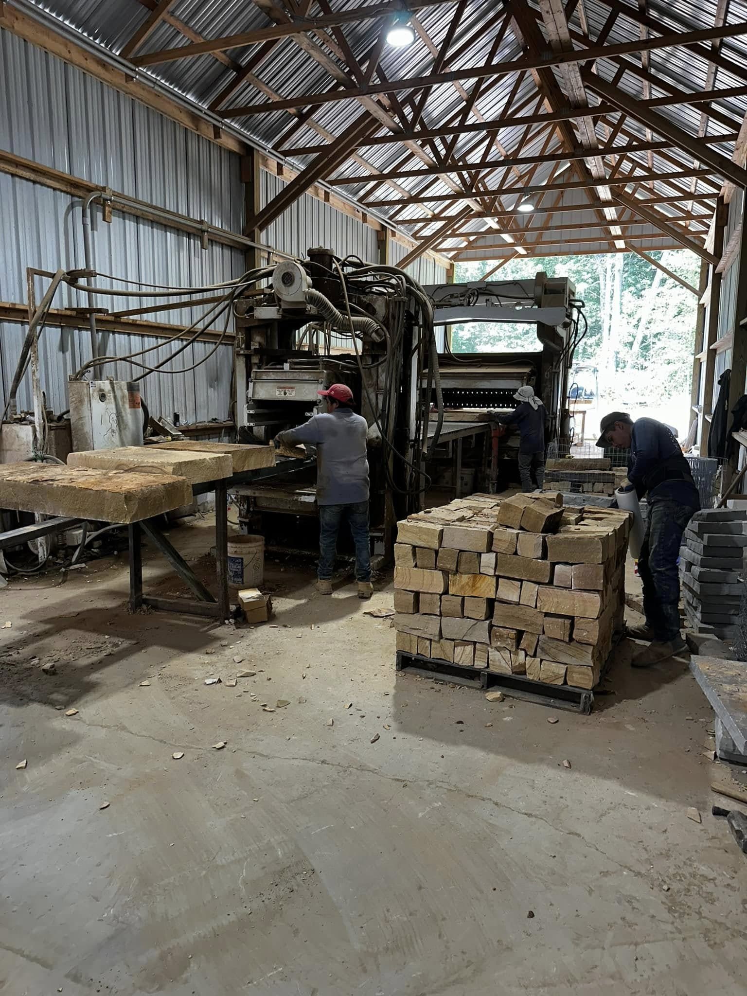 Workers cutting stone to order at the Deer Creek Stone facility