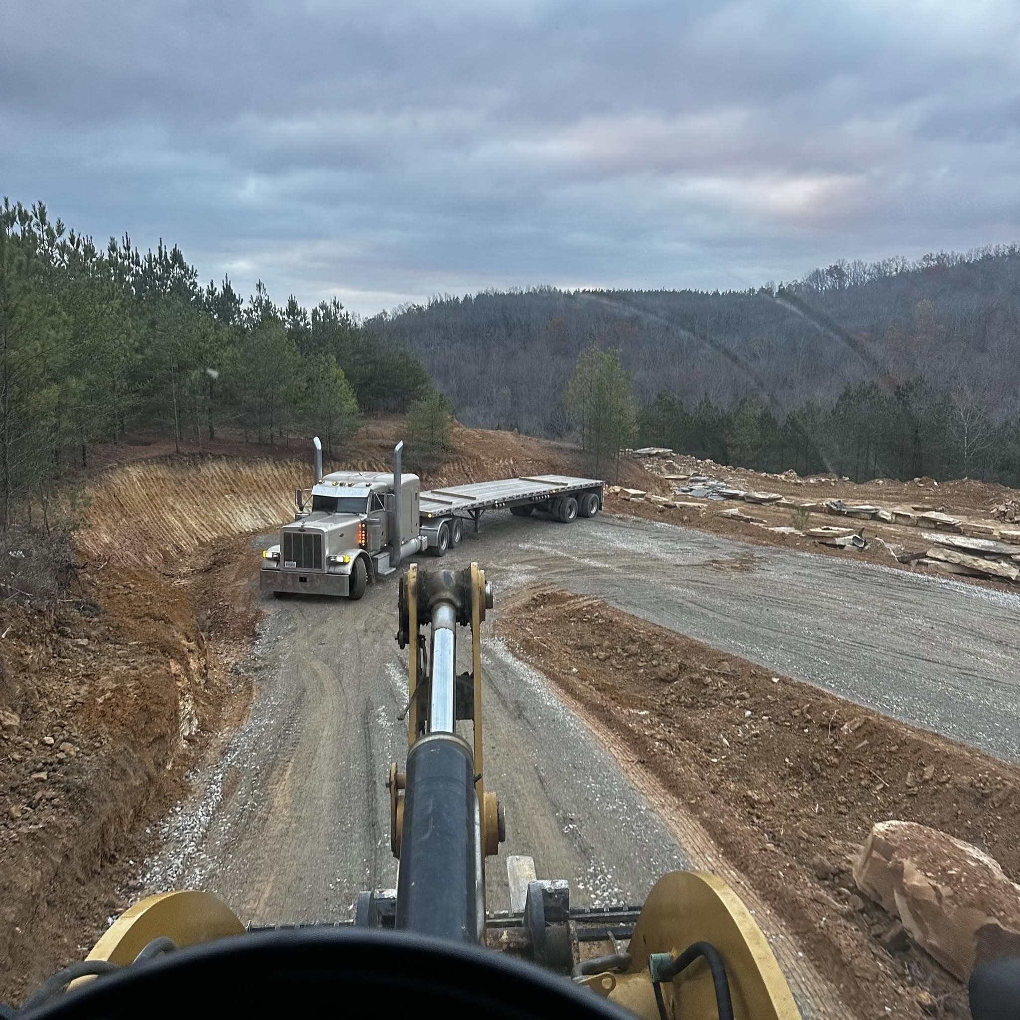 A flatbed truck loaded with Deer Creek Stone pallets at the quarry
